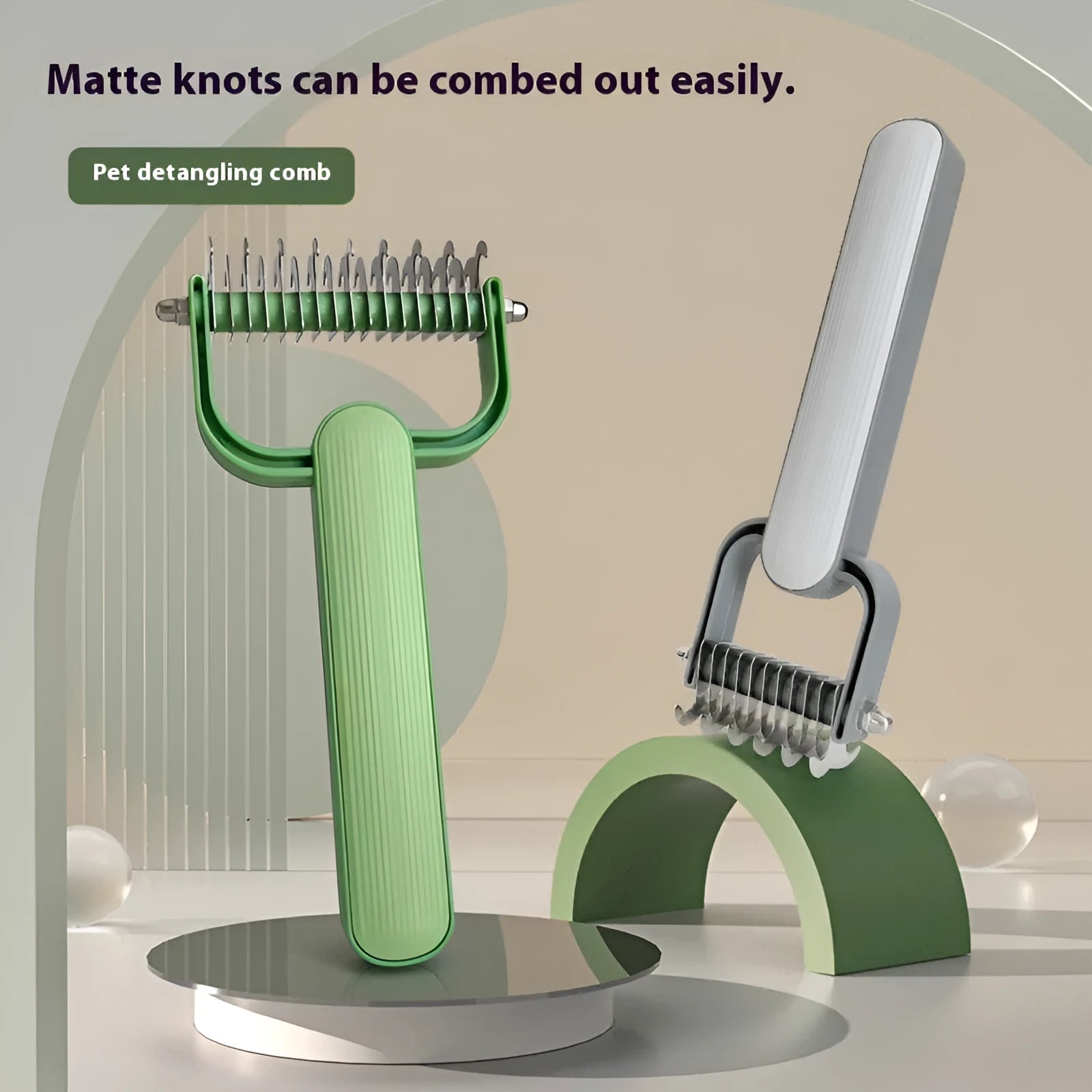 Green and grey dog detangling comb with stainless steel teeth on a polypropylene handle.