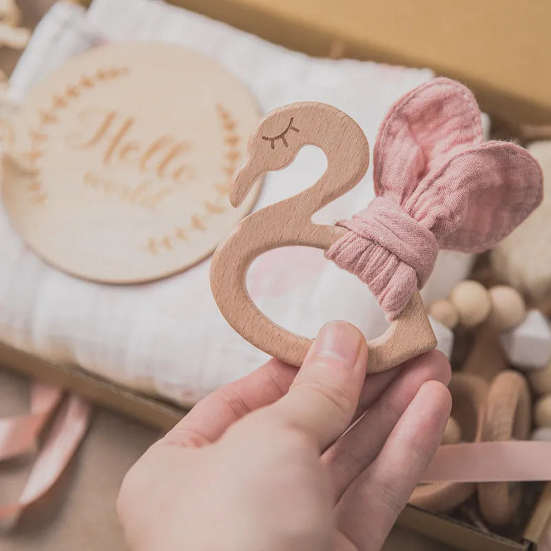 Newborn baby shower toy set with 6 bath toys in peach, blue, and brown from wood and chemical fibre