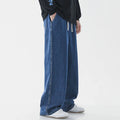 Man wearing loose straight cotton jeans in solid colour, casual fit with straight legs