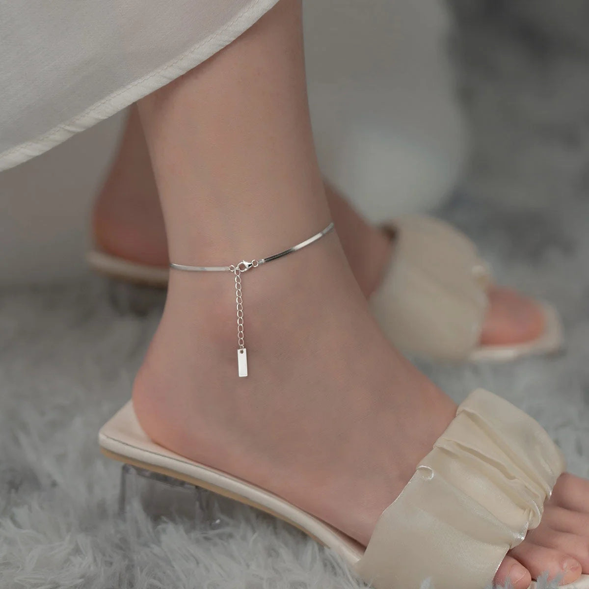 S925 silver snake bone chain anklet in silver and gold finishes, showcasing unique design and craftsmanship.