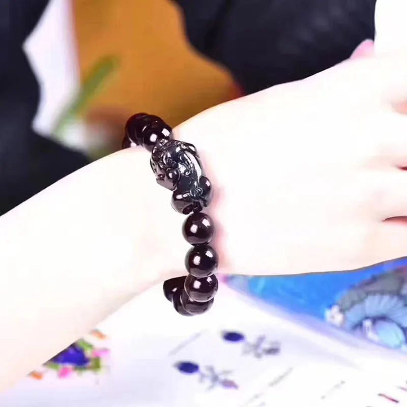 Natural Ice Obsidian beaded bracelet on wrist showing pale crystal beads.