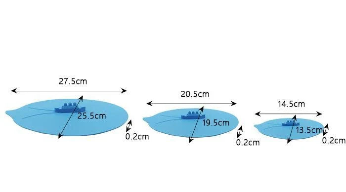 A silicone cooking lid with a ship-inspired design, featuring a three-port steam release system and a convenient hook for easy storage.