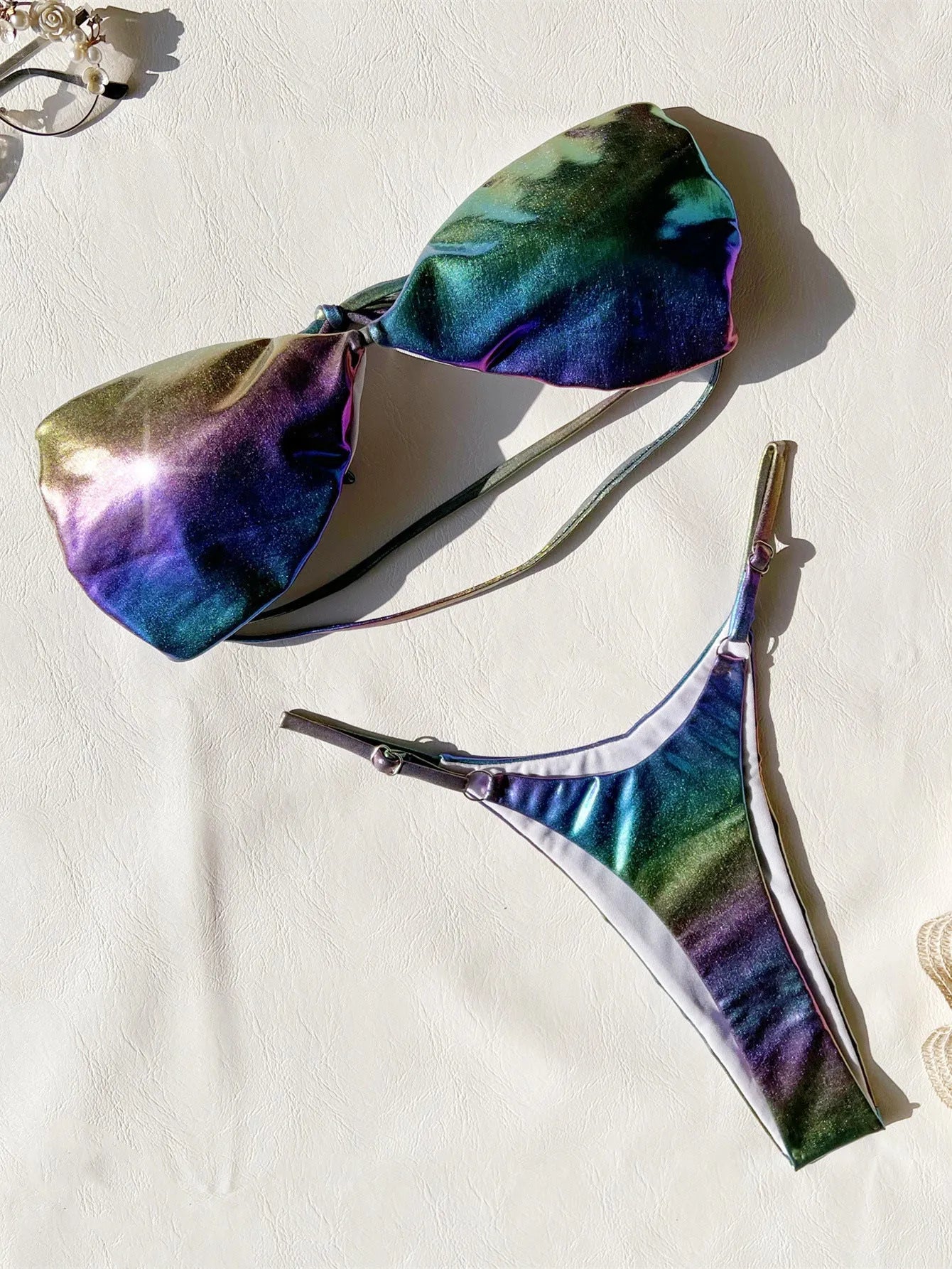 Women's gradient purple polyester bikini swimsuit laid flat, showing top and bottom.