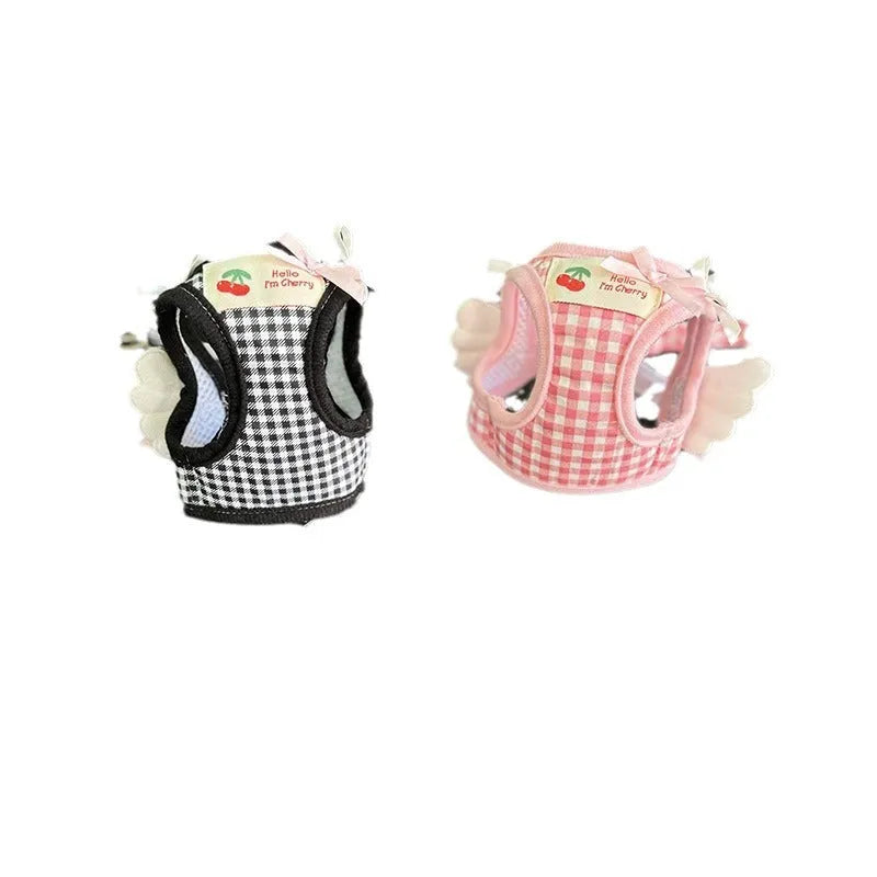 A pink cotton chest and back harness with a hand holding rope for a small dog.