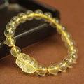 Yellow Pi Xiu bracelet with artificial crystal beads on an adjustable leather strap.