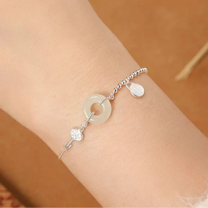Women's Hetian jade bracelet in 925 silver with peace buckle charm, geometric Chinese style design