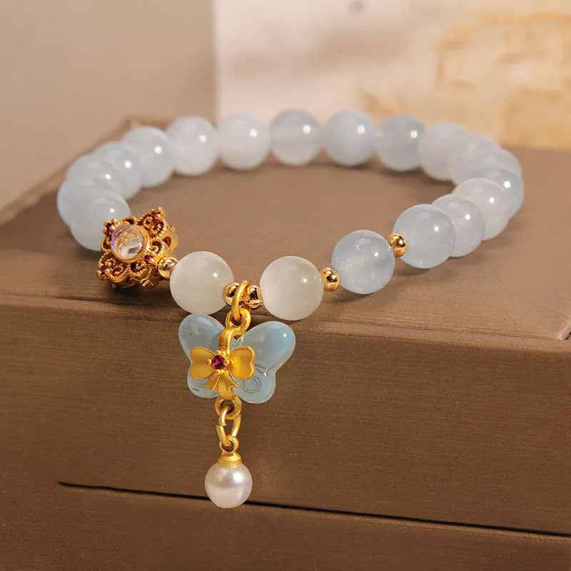 Women's aquamarine butterfly pendant crystal bracelet with rhinestone detailing on wrist