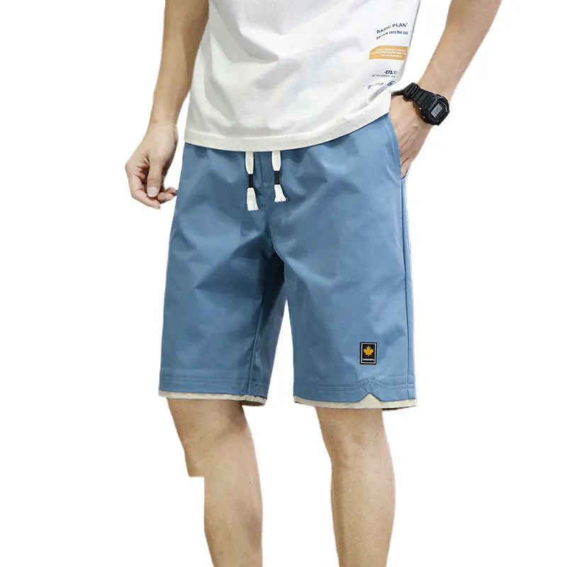 Casual straight-leg loose shorts in green polyester fabric on a neutral background.