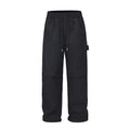 Black baggy paratrooper trousers with an elasticated drawstring waistband and three-dimensional cutting.