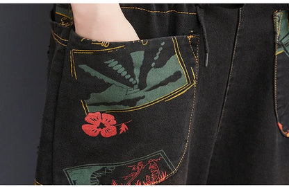 Plus size floral print suspender jeans in black and blue, made from durable denim cotton.