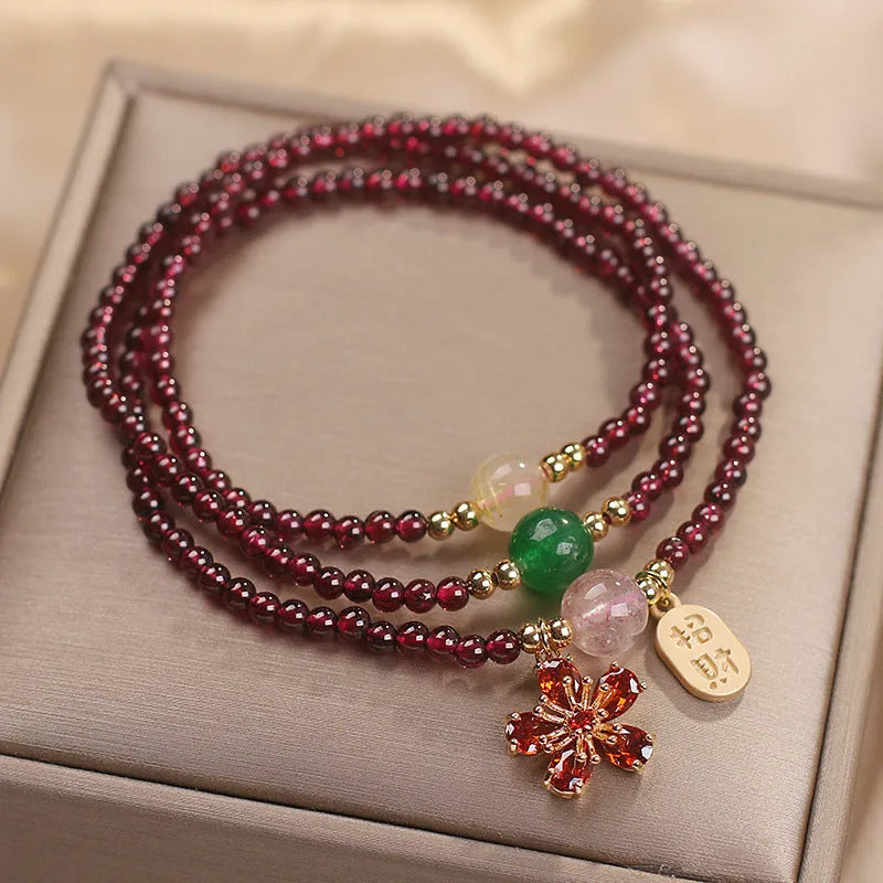 Natural crystal bracelet for women in pomegranate red cherry blossom colour with sequin detailing.