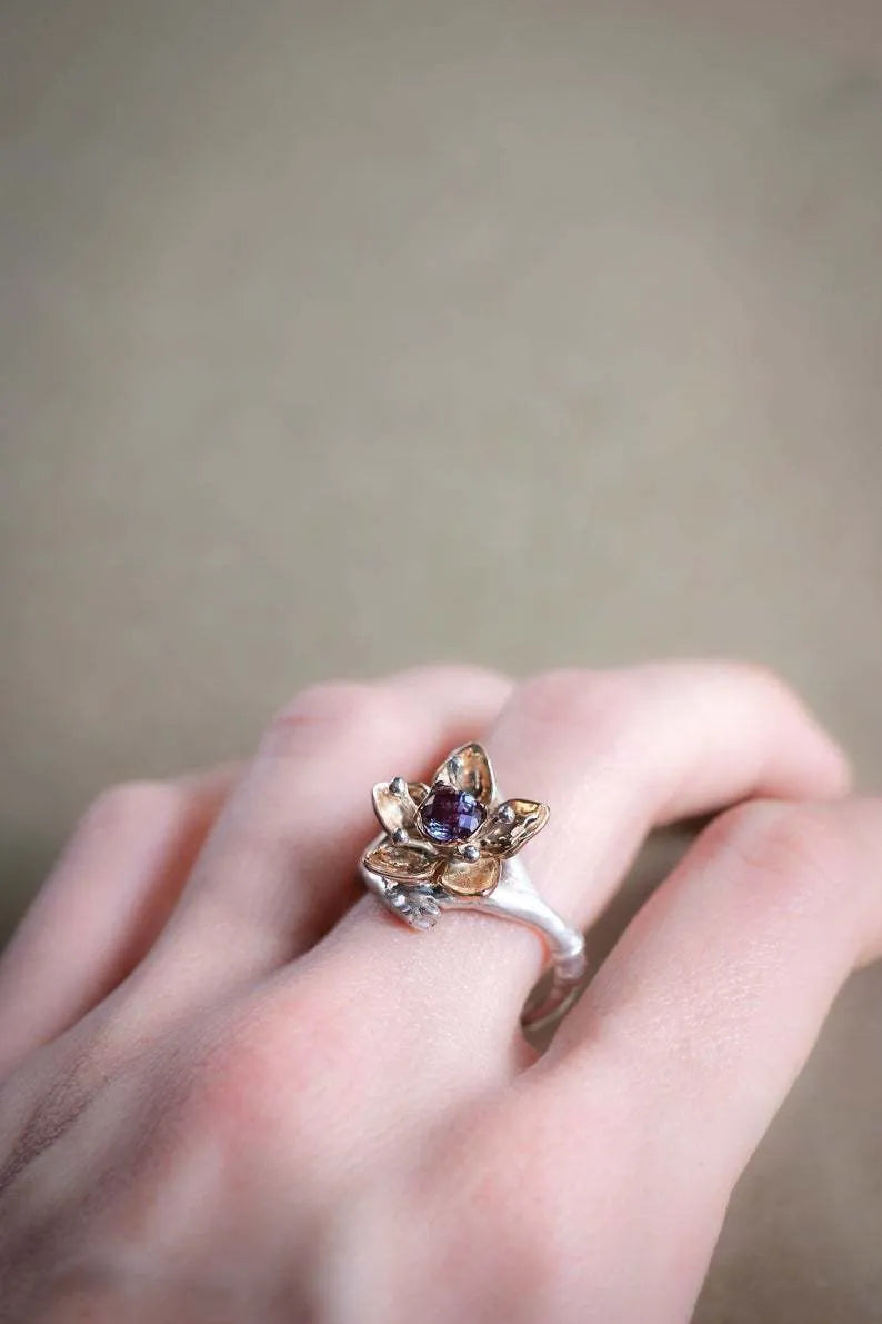 Silver two-tone floral pattern geometric alloy fashion ring for women on a grey background.