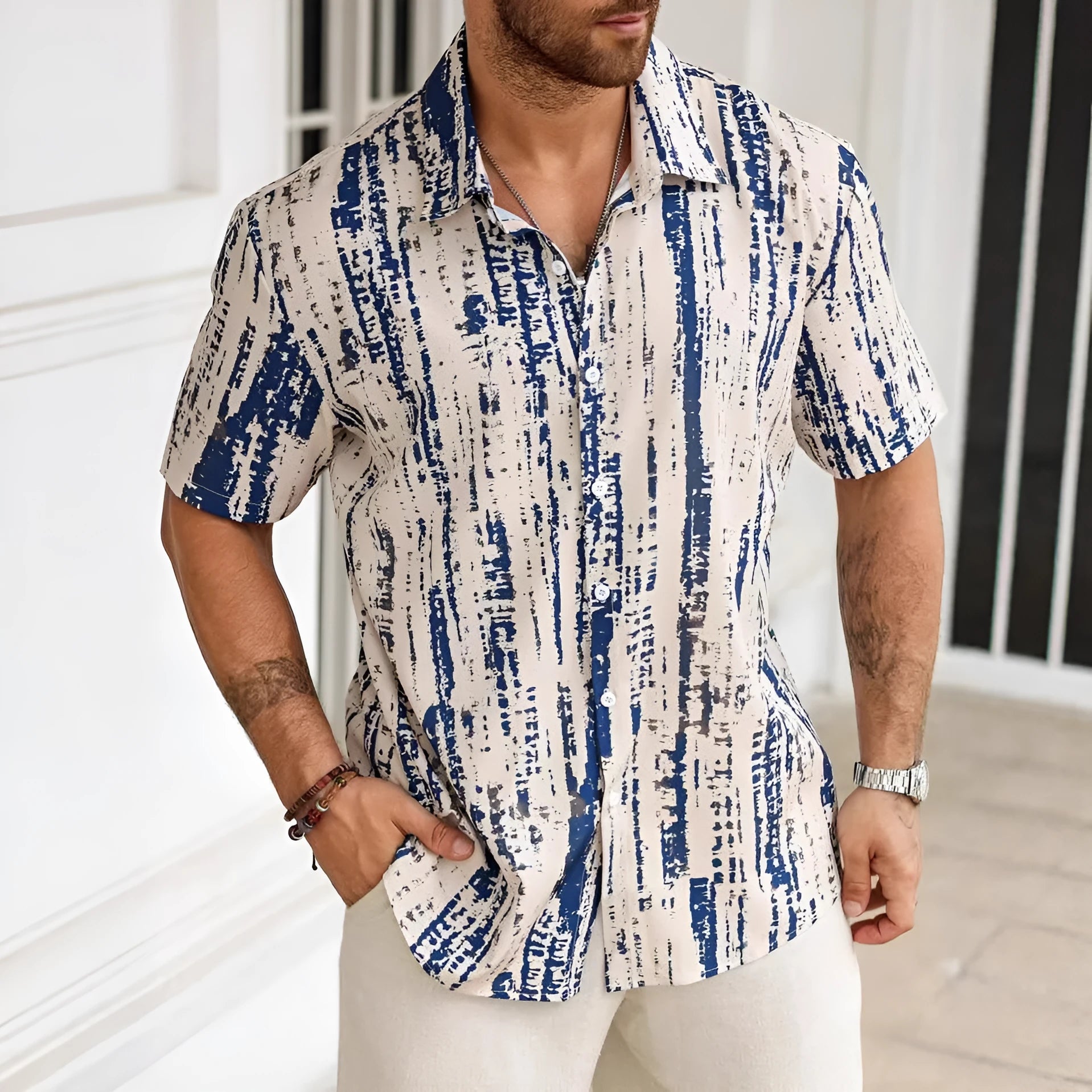 Man wearing a blue striped short sleeve casual shirt with 3D printing detail.