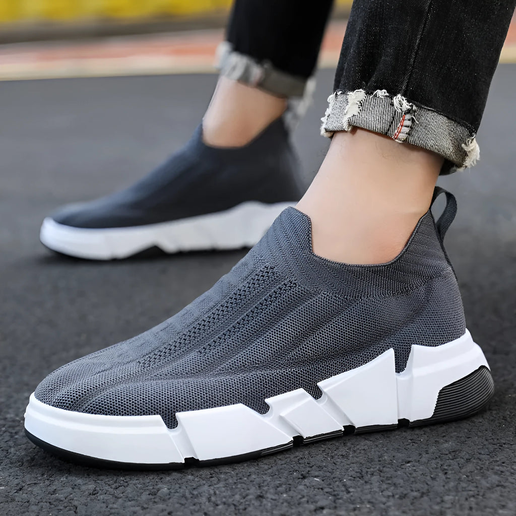 Men's slip-on casual sports shoes with black flyknit mesh upper and sock cuffs, flat PVC sole