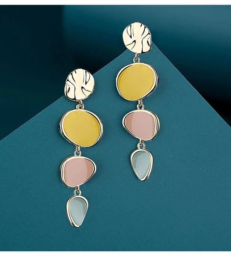 A pair of simple disc-shaped alloy earrings with a Morandi colour oil-drip finish on a sterling silver post.