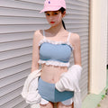 Women's conservative one-piece swimsuit with suspenders in a solid colour.