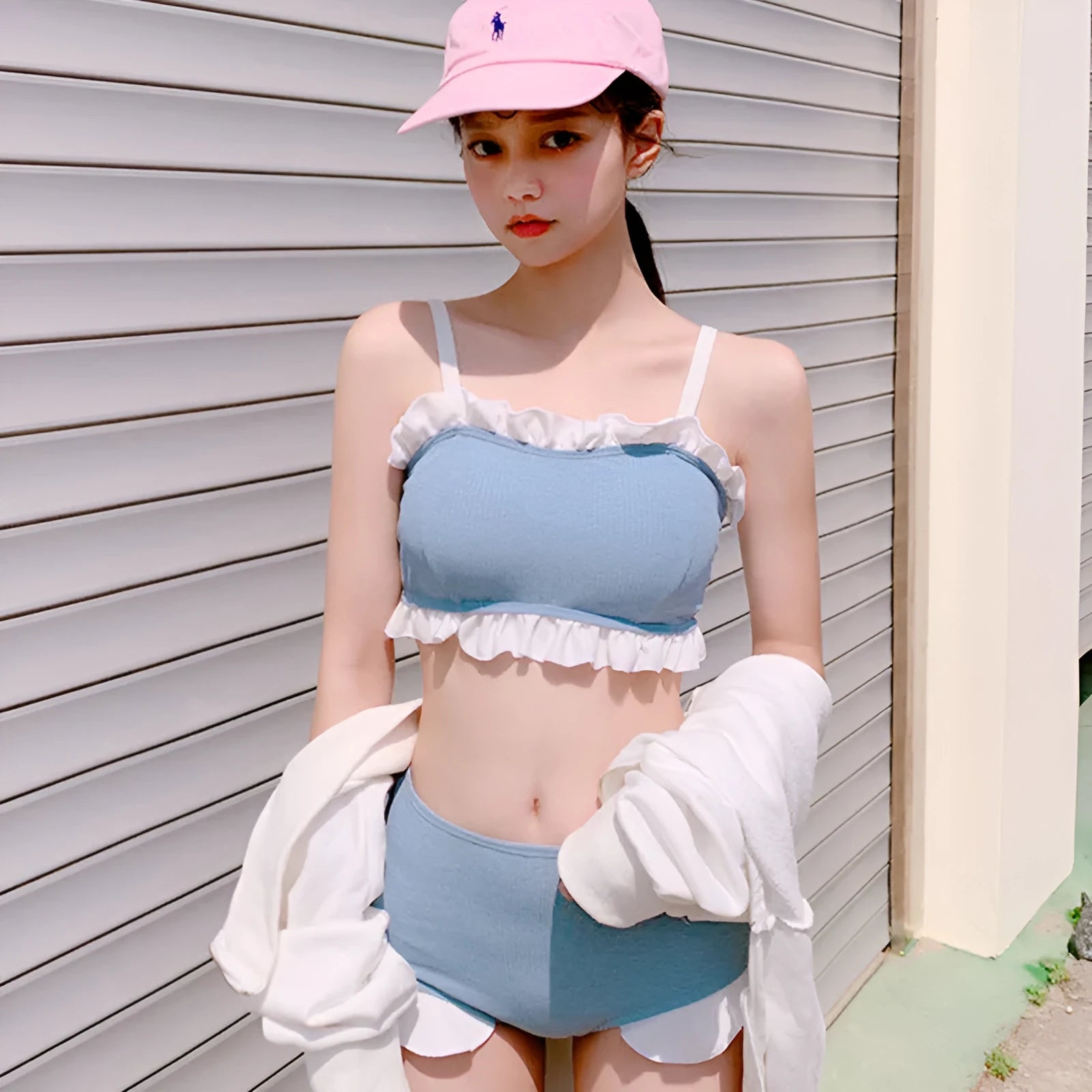 Women's conservative one-piece swimsuit with suspenders in a solid colour.
