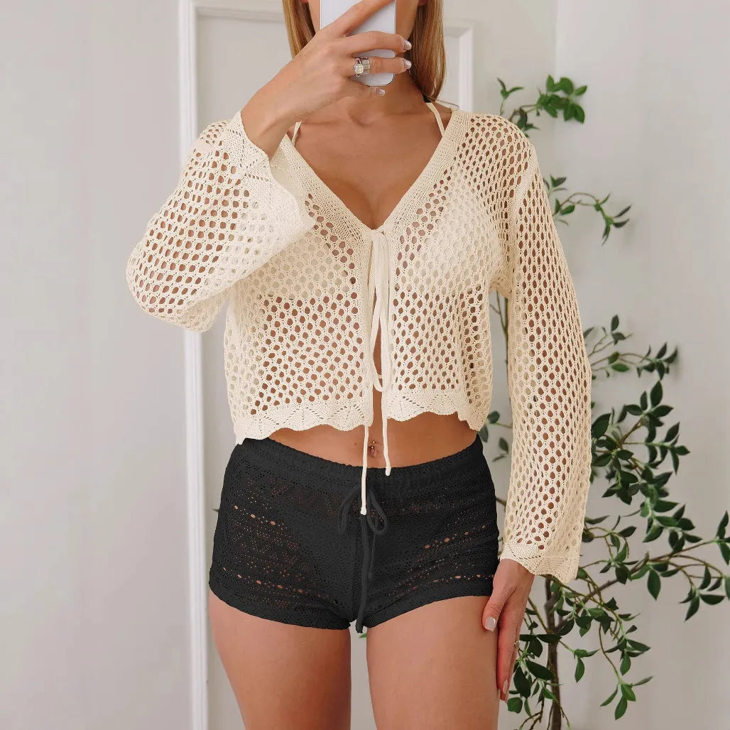 Short apricot-coloured women's cardigan blouse with bell sleeves, showing hollow woven texture.