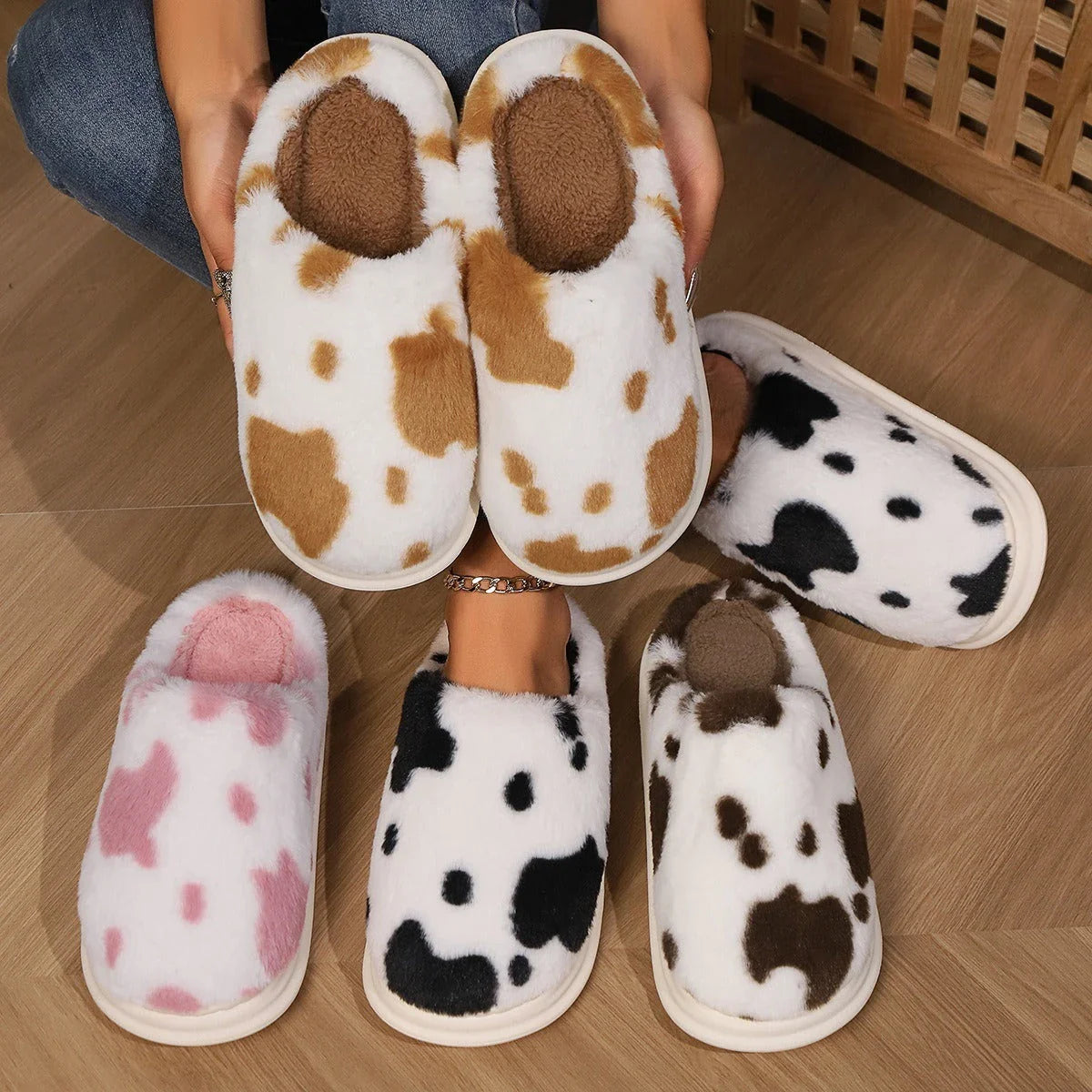 A pair of cozy, plush slippers with a unique spotted pattern, designed for warm and comfortable indoor wear.