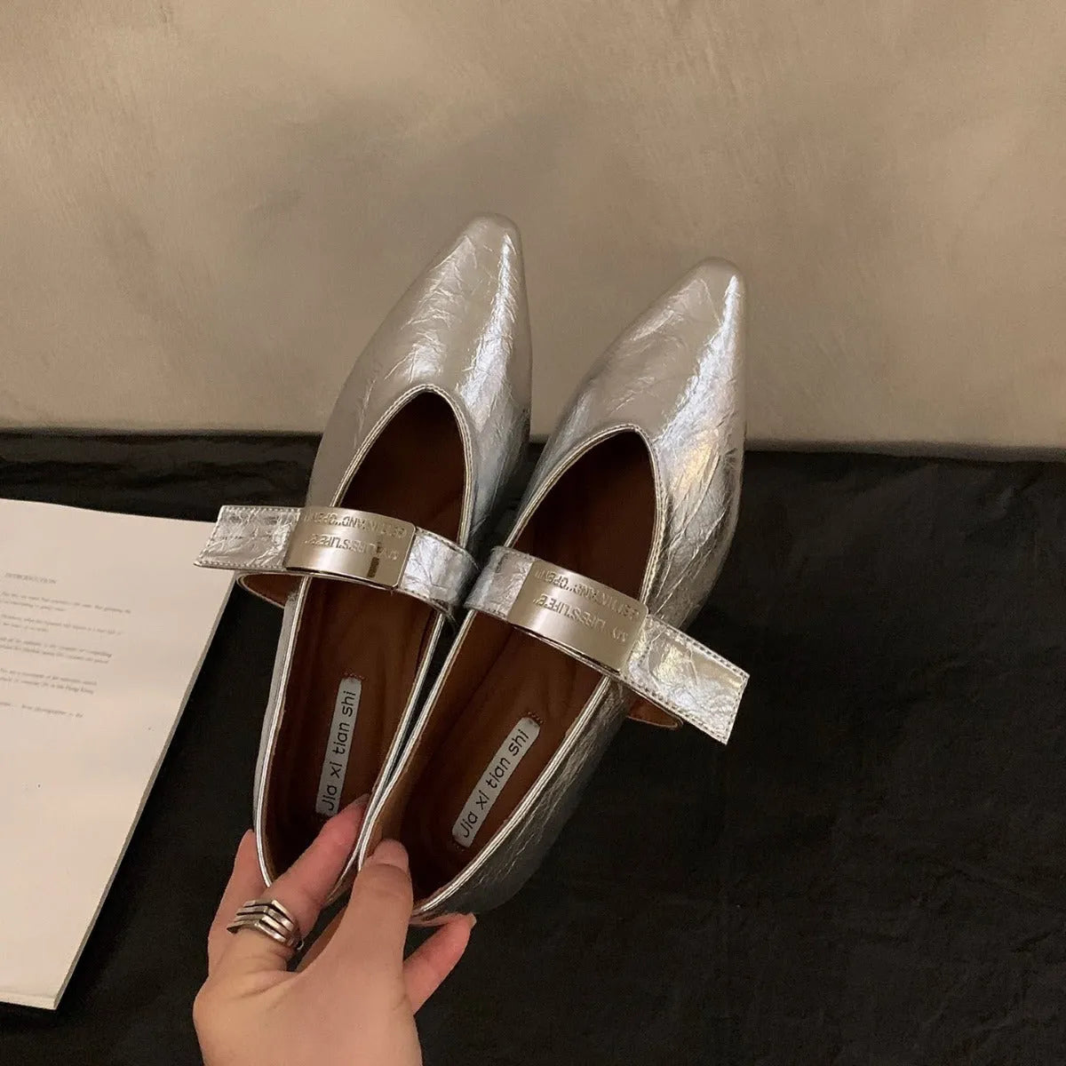 Women's silver Mary Jane shoes with pointed toe, buckle fastening, and low heel