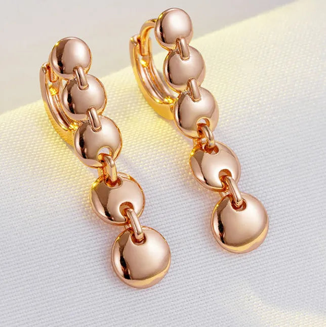 Gold tone retro long circle earrings with woven texture on a copper base.