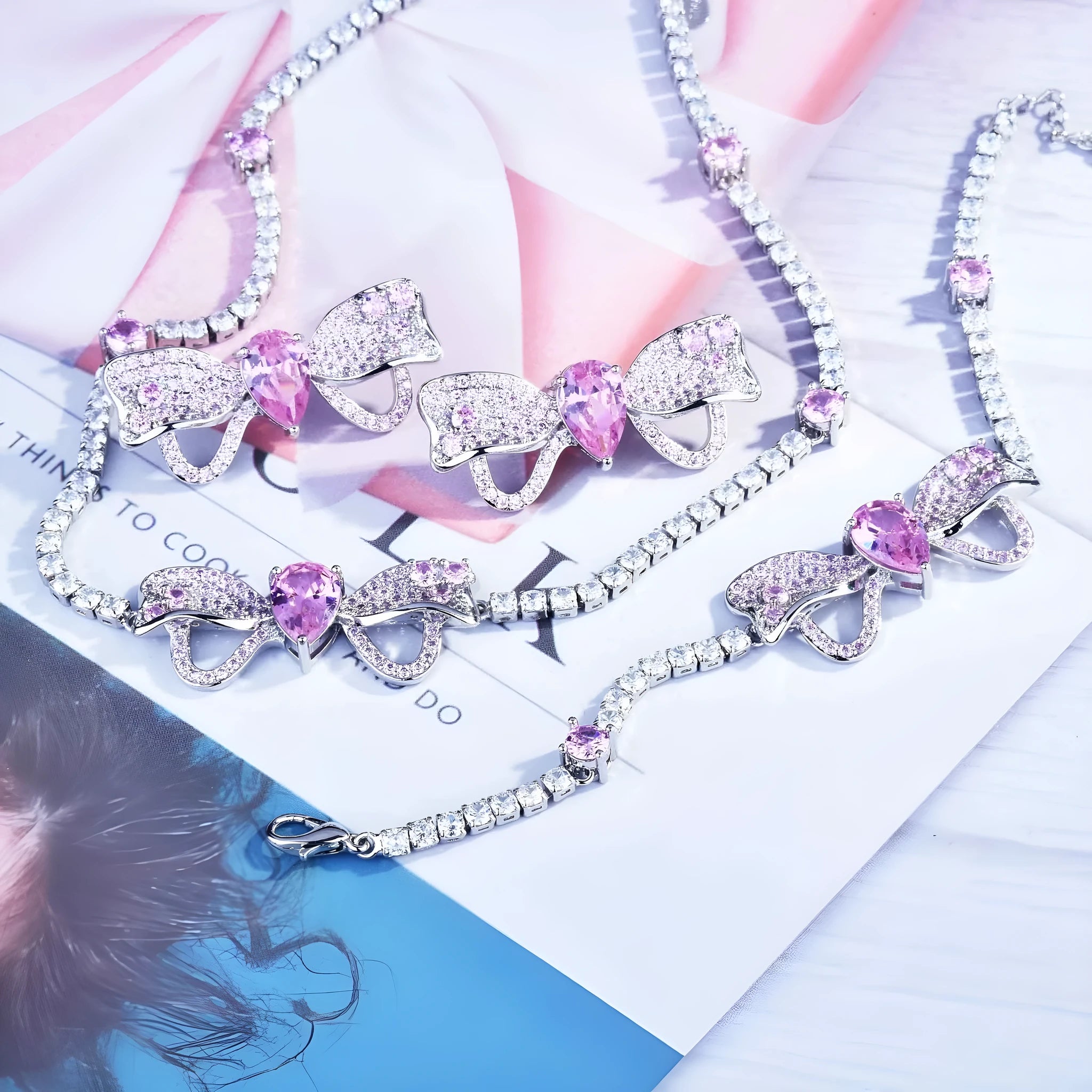 Full diamond bow jewellery set with necklace, bracelet, and ear studs in copper with mixed gem inlay