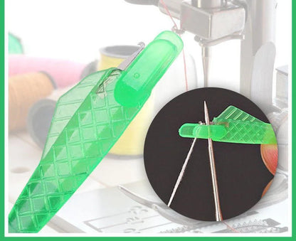 Small fish design needle threader for sewing machines in green, metal and plastic construction