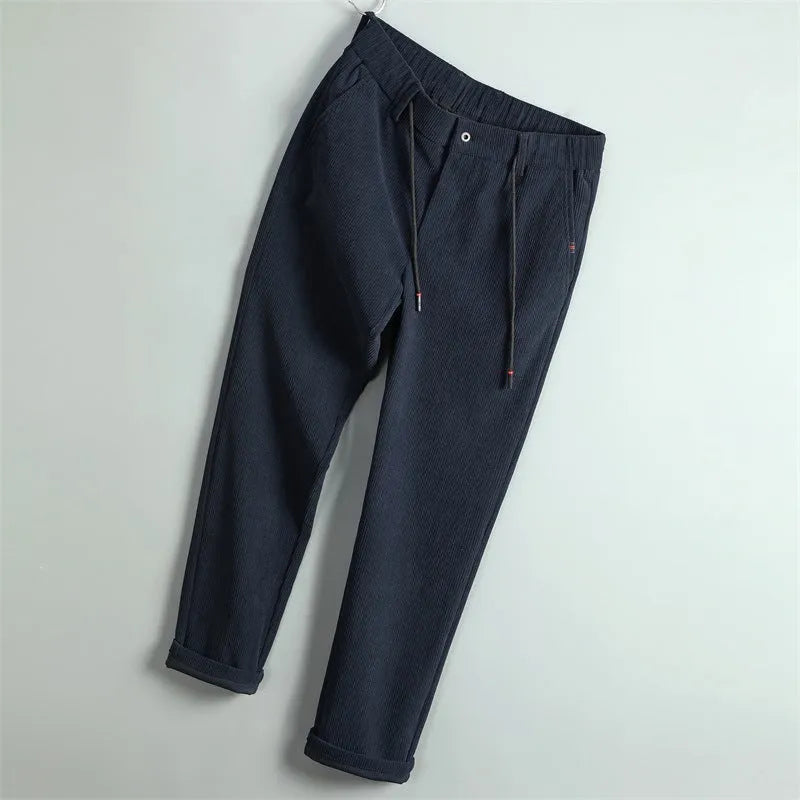Men's casual striped polyester trousers in black, size 30, front view