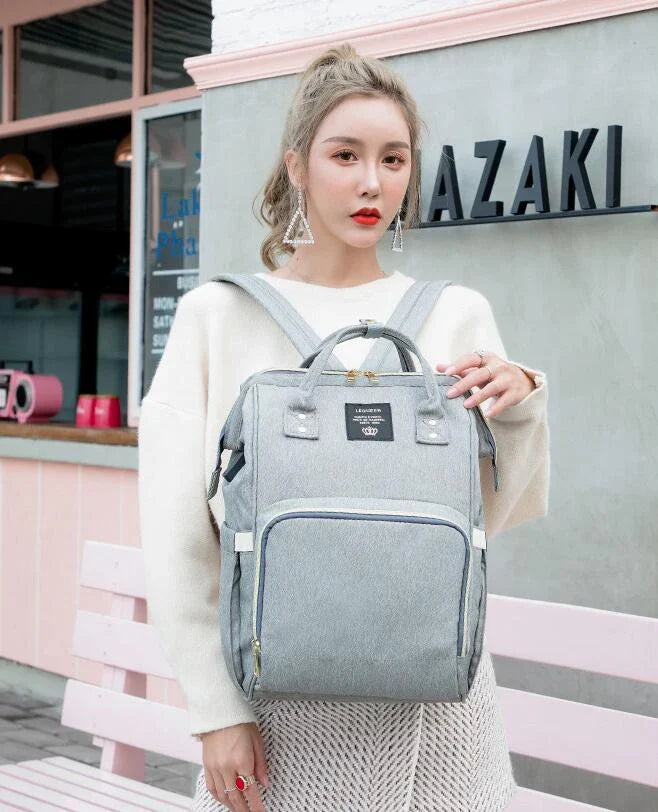 A stylish and practical mummy backpack with features like an insulated bottle compartment, USB charging port, and water-resistant construction.