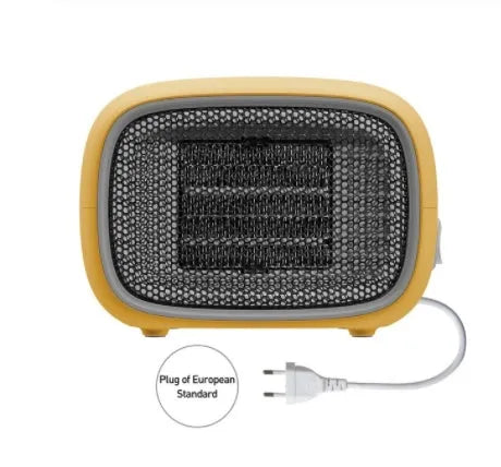 Compact green portable ceramic fan heater on a wooden desk