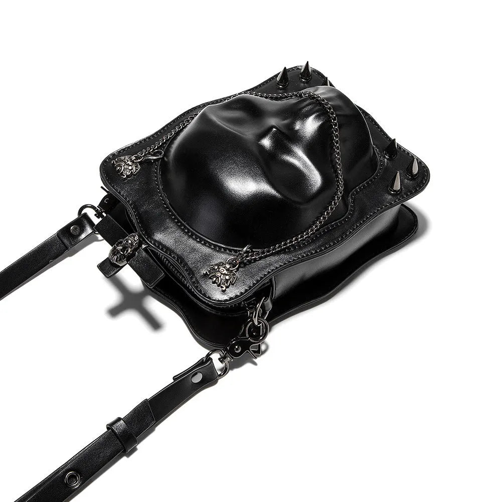 Black mini square crossbody bag with detailed skull embossing, rivets, and a shoulder strap.