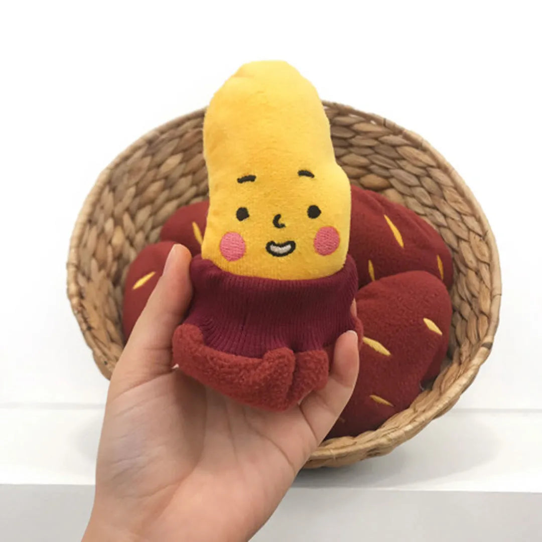 Red sweet potato-shaped dog toy with a peelable layer and hidden treat pocket for interactive play.