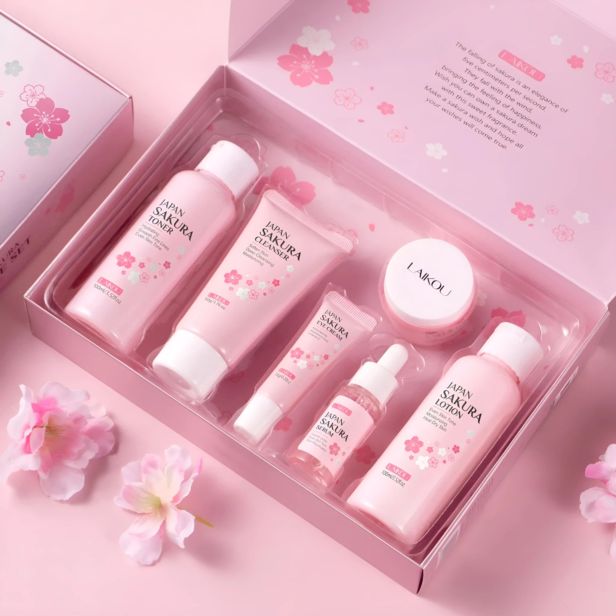 Boxed Cherry Blossom 6-piece skincare set showing cleanser, toner, creams, and serum.