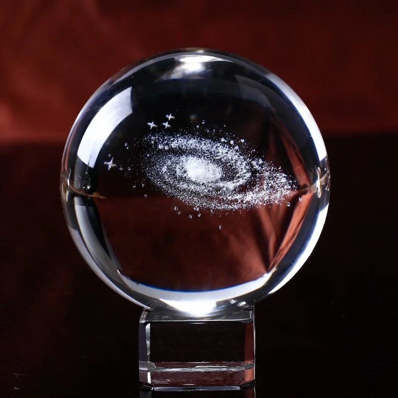 Mesmerizing Galaxy Crystal Ball made with premium K9 crystal, showcasing swirling celestial patterns and available in various sizes and base options.