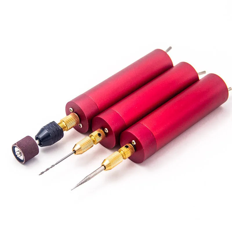 Aluminium USB mini grinder with three small drill bits and a wrench on a white background.