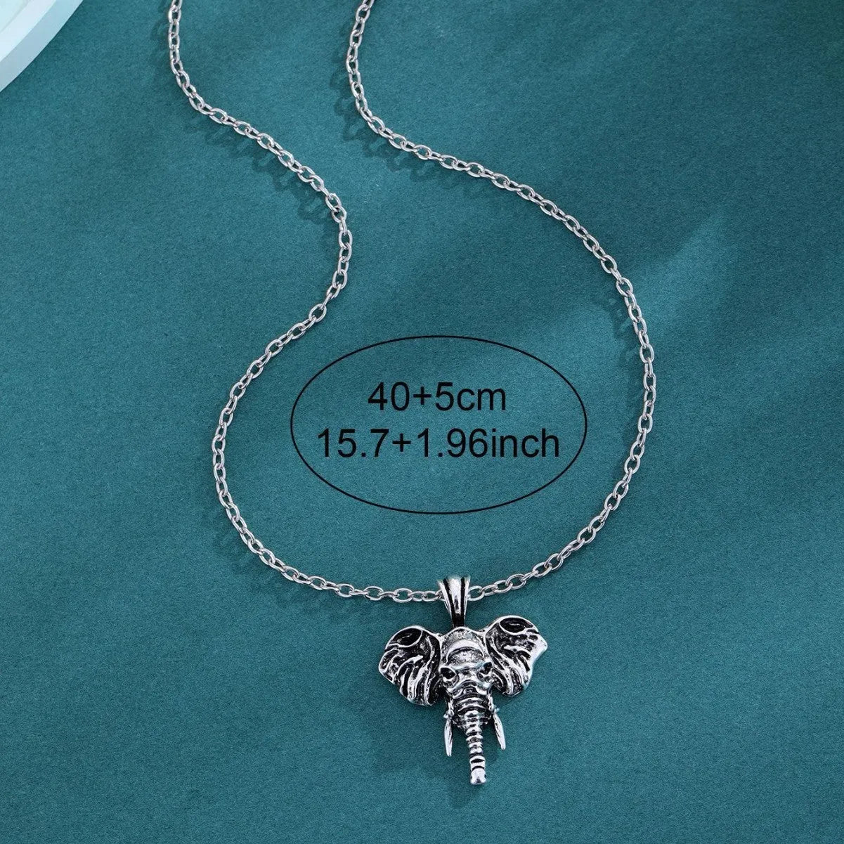 Silver and black elephant god pendant necklace on display, stainless steel construction for men.