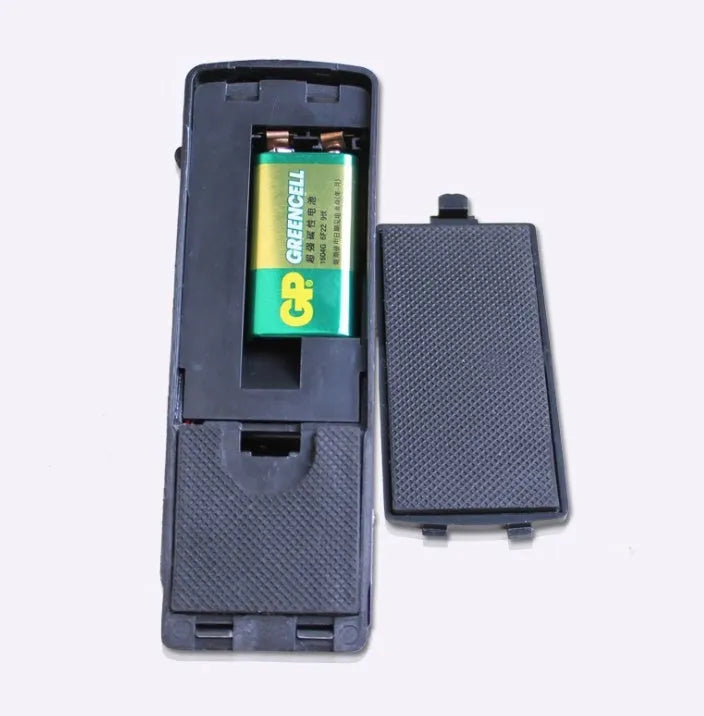 Black wedge-shaped door alarm with stainless steel cover and sensitivity controls