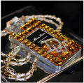 iPhone case with perfume bottle bow design, TPU silicone construction, and attached metal chain