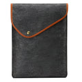 Flat felt bag computer bag in dark grey with magnetic buckle closure on a flat surface