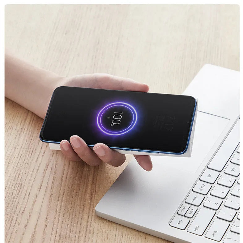 White or black 10000mAh power bank with USB port and wireless charging for tablets and phones.