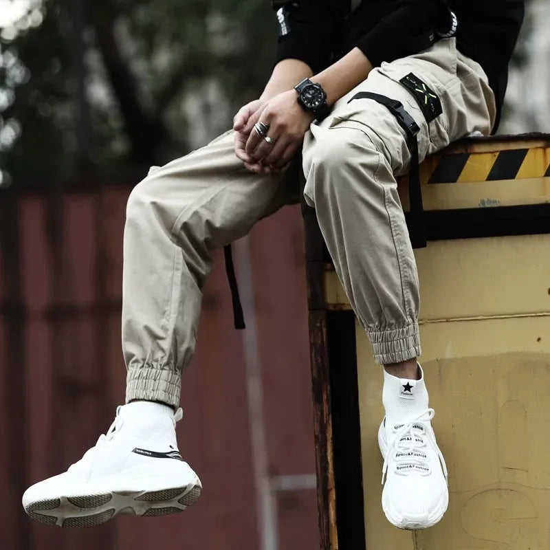Men's casual cotton cargo pants in black with multiple pockets, available in Asian sizes S to XL