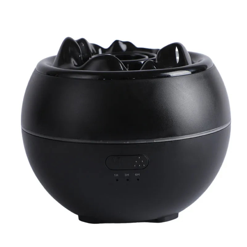 White round flame aroma diffuser and humidifier with water tank on a wooden desk
