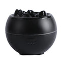 White round flame aroma diffuser and humidifier with water tank on a wooden desk