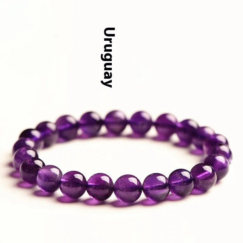 Natural amethyst Uruguay bracelet with scattered polished beads in violet tones, shown in a single circle design.