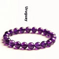 Natural amethyst Uruguay bracelet with scattered polished beads in violet tones, shown in a single circle design.