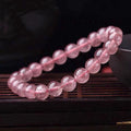 Women's strawberry quartz crystal bracelet showing polished natural stones in 6mm, 8mm or 10mm bead sizes