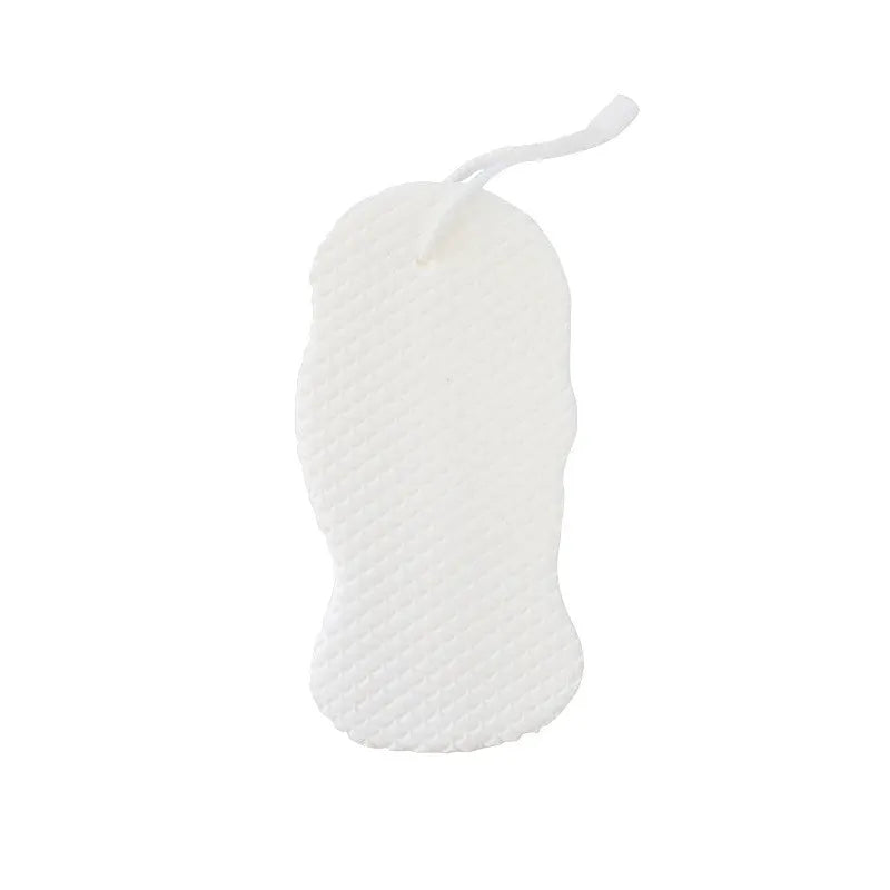White 3D fish scale pattern bath sponge ball on a bathroom surface.