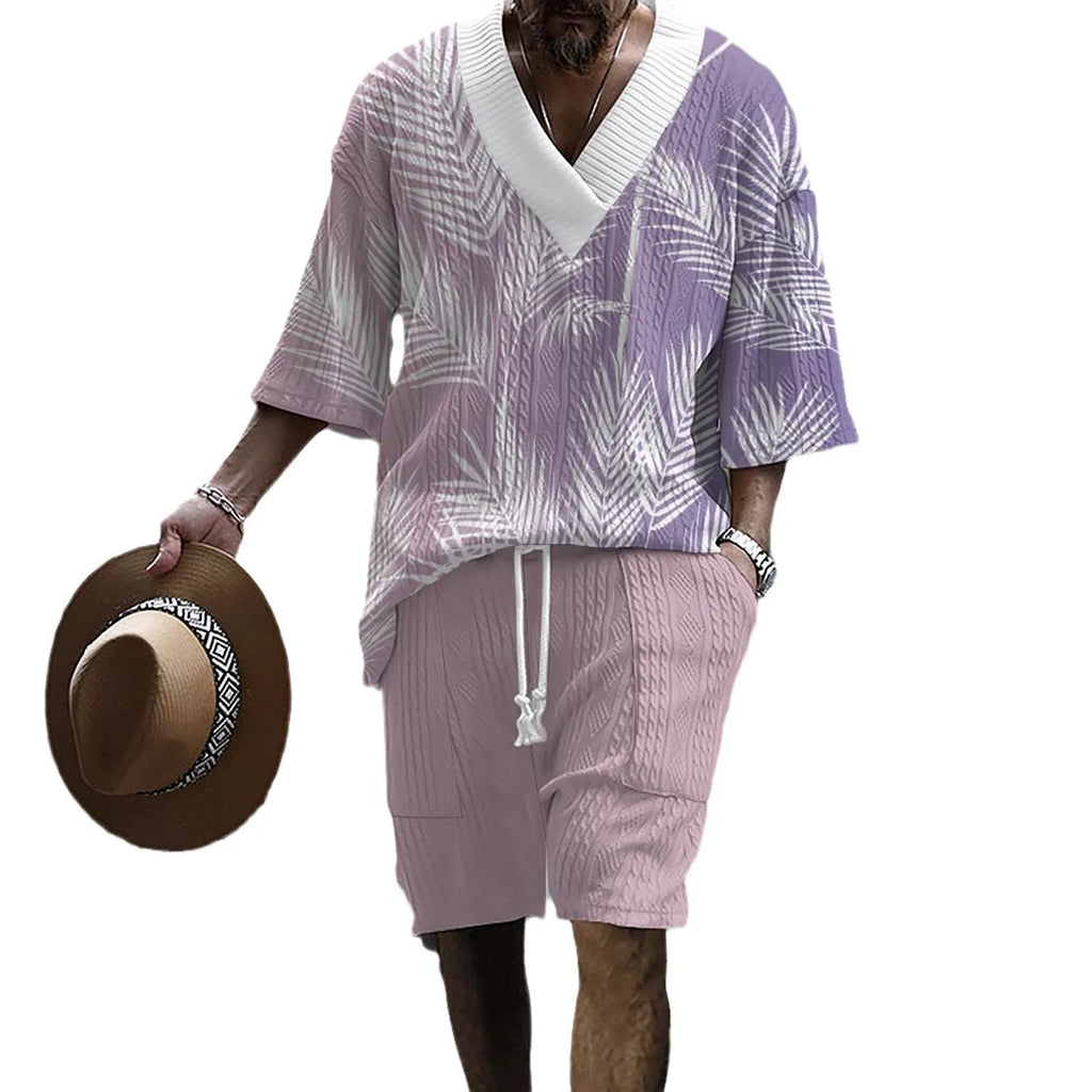 Man wearing a solid colour knitted short-sleeved top and matching shorts, showing the drop-shoulder design.