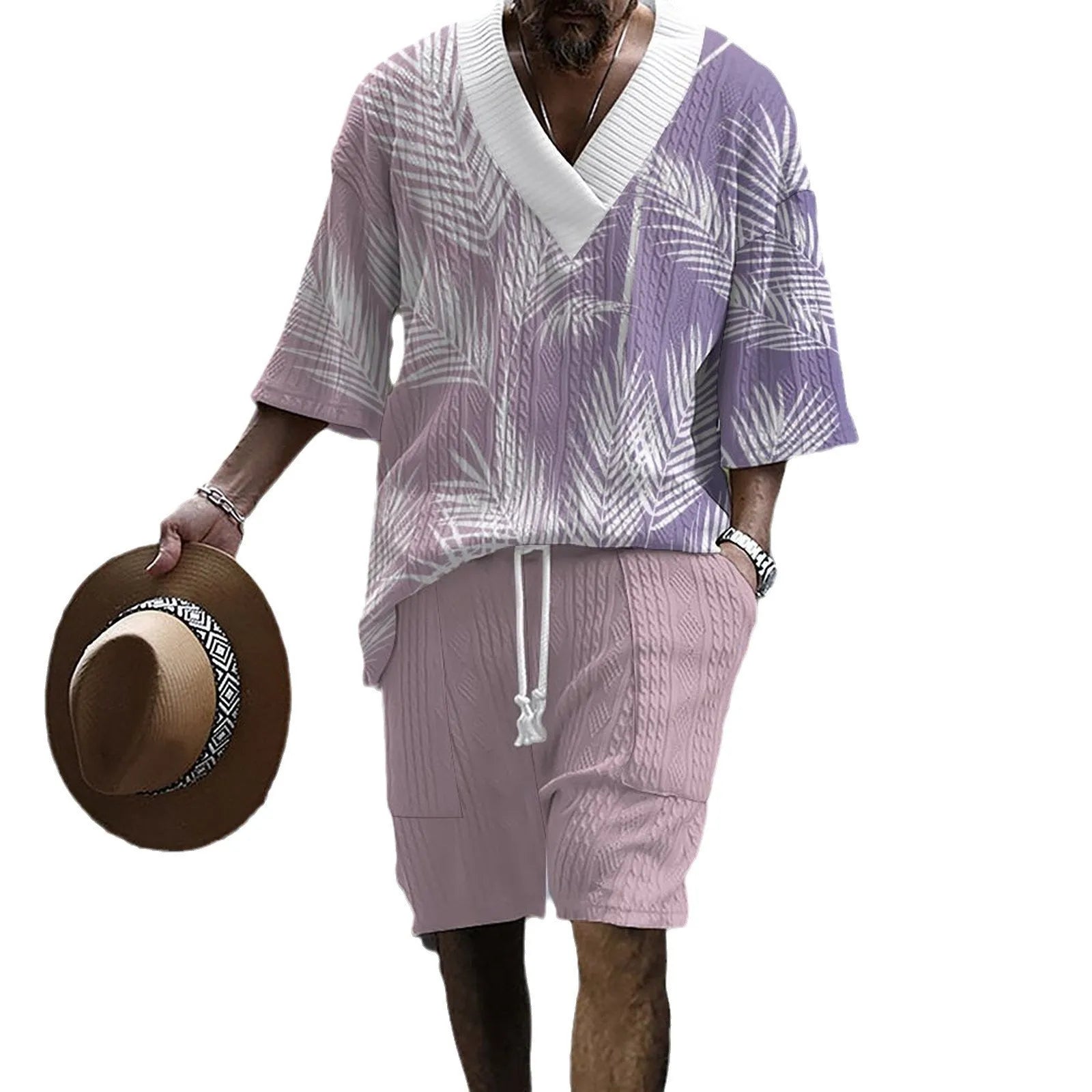 Man wearing a solid colour knitted short-sleeved top and matching shorts, showing the drop-shoulder design.