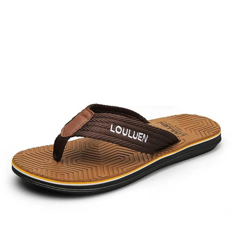 Men's black flip flops with textured non-slip PVC sole and EVA upper on a sandy beach.